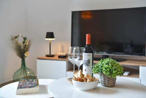 a bottle of wine and glasses on a table at Carmencita in Moraira