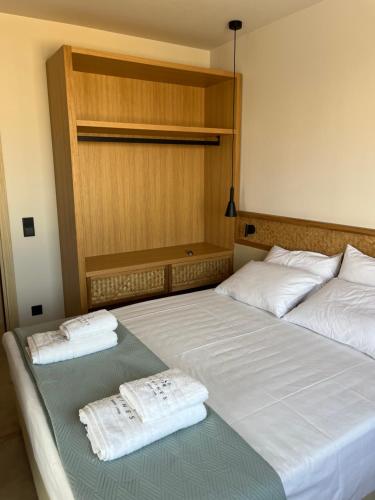 two beds sitting next to each other in a room at Thines Comfort Living in Néa Péramos