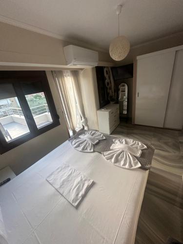 a large white bed in a room with a window at Lajes Apartment in Skala Potamias