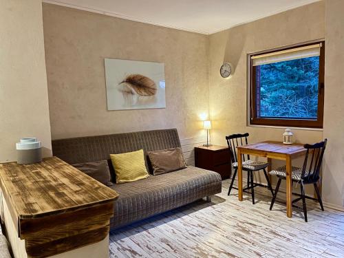 a living room with a couch and a table at Willa Avita in Karpacz