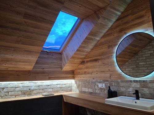a bathroom with a sink and a window at Sileo Nature in Ustka