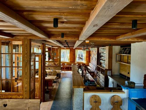 a kitchen with wooden ceilings and a dining room at Aldrov Resort in Vítkovice