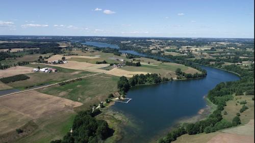 an aerial view of a river with a group of properties at 4 Glamping Adventure - tent with lake view in Filipów