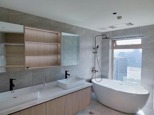 a bathroom with a tub and a sink and a window at Shanghai Skyline - Spacious&Elegant Luxury Apartment in Lujiazui near Shanghai Center Tower in Shanghai