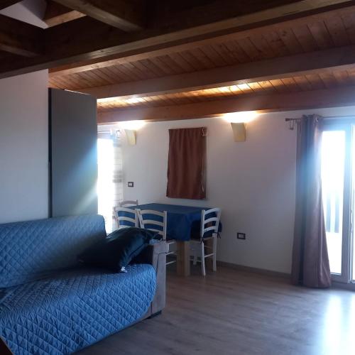 a bedroom with a bed and a table and a dining room at Casa Dora in Porto Pino