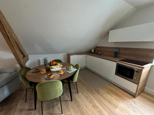 a kitchen with a table and chairs in a room at Hélios Plage in Berck-sur-Mer