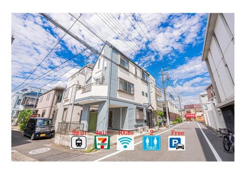 a building with signs in front of it on a street at Private 3 Bedroom House with Free Parking Near Asakusa and Skytree in Tokyo