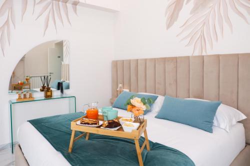 a bed with a tray of food on a table at Royal House in Santa Maria La Carità