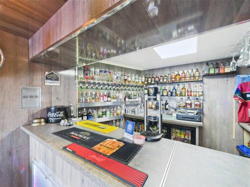 a bar with a lot of bottles of alcohol at Kings Boutique Hotel in Blackpool
