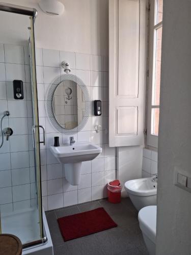 a bathroom with a sink and a mirror and a toilet at Aghinas in Bosa
