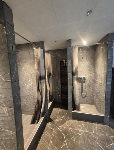 a bathroom with a shower and two mirrors at Hostel Hakuna Matata in Dubrovnik