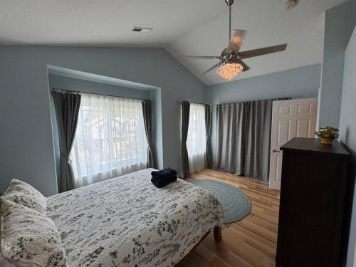 a bedroom with a bed and a ceiling fan at A House On Catalina in Tigard