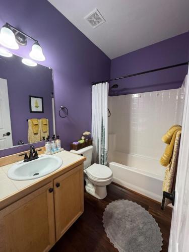 a bathroom with a sink and a toilet and a tub at A House On Catalina in Tigard