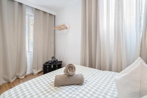 une chambre avec un lit avec un chapeau dessus dans l'établissement Nice Renting - 35 Massena - Architect Flat Ultimate Charm Massena Center, à Nice