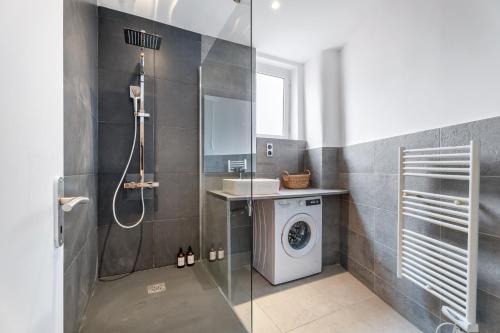 une salle de bain avec douche et machine à laver dans l'établissement Nice Renting - 35 Massena - Architect Flat Ultimate Charm Massena Center, à Nice