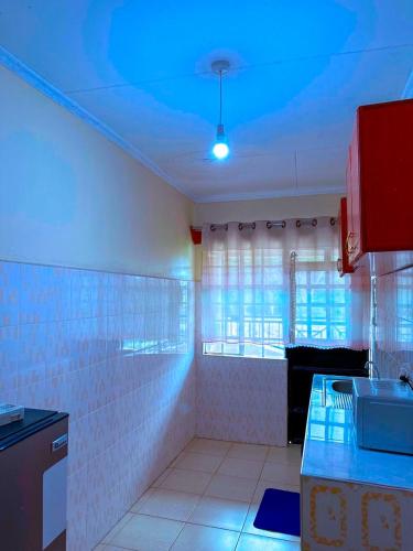 a kitchen with a blue light on the ceiling at Lakeside Two Bedroom Penthouses in Goat Island