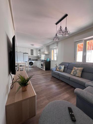 a living room with a couch and a table at La Casa de la Vergel in Torrelavega