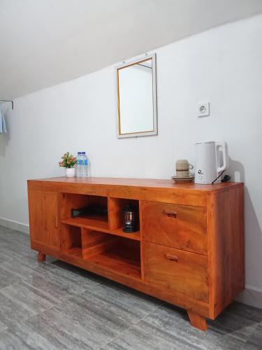 a wooden cabinet with a microwave on top of it at Stokel Cottage in Praya