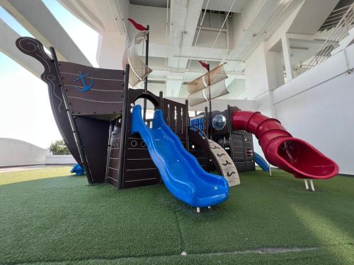 a play room with a slide and slidesktop at Luxury 2BR at Heart of Melaka in Melaka