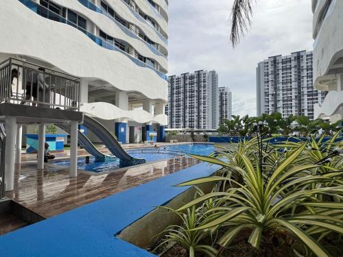 a swimming pool with a slide in a building at Luxury 2BR at Heart of Melaka in Melaka