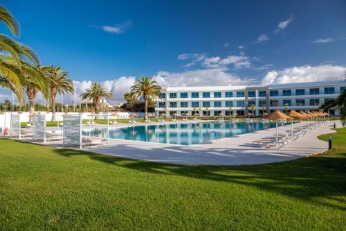 a hotel with a large swimming pool in front of a building at Ancora Park - Sunplace Hotels & Resorts in Lagos