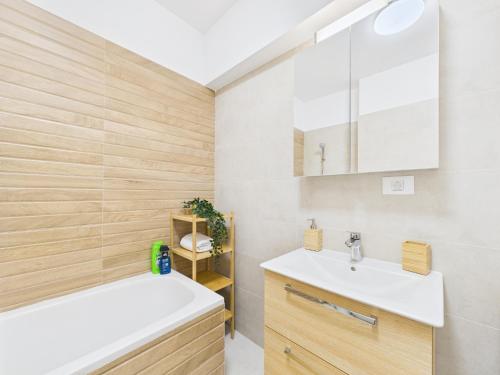 a bathroom with a white sink and a tub at Lujerului Studio in Bucharest