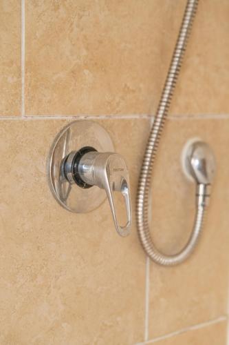 a shower with a shower head in a bathroom at Clydebank 2 Bedroom Home in Drumchapel