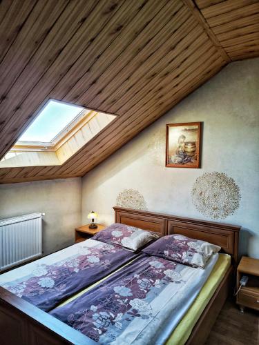 a bedroom with a bed and a skylight at Michałek w Rowach in Rowy