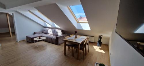 a living room with a couch and a table at Eva apartments & free-parking in Klaipėda