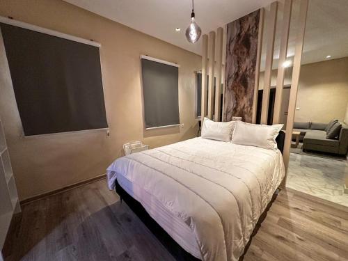 a bedroom with a large bed and a couch at Relax Family 06 - Cozy Studio in City Center in Ouarzazate
