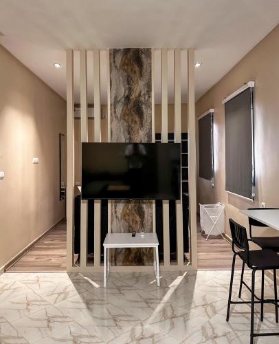 a living room with a large flat screen tv on a wall at Relax Family 06 - Cozy Studio in City Center in Ouarzazate