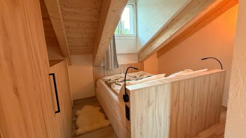 a small room with two beds in a attic at La Tana del Cervo del Maso K in Folgaria