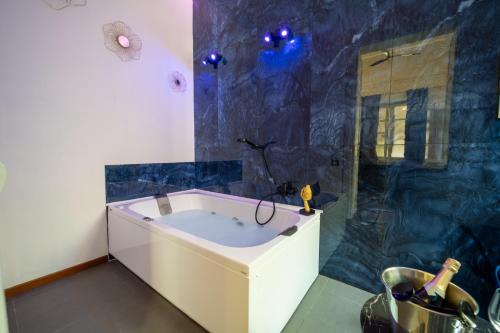 a large bathroom with a tub and a shower at Le suite di Alba in Palermo
