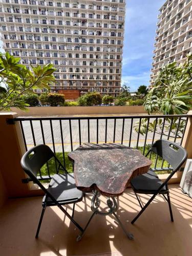 a table and two chairs on a balcony at StudioFlat BelFont in Lapu Lapu City