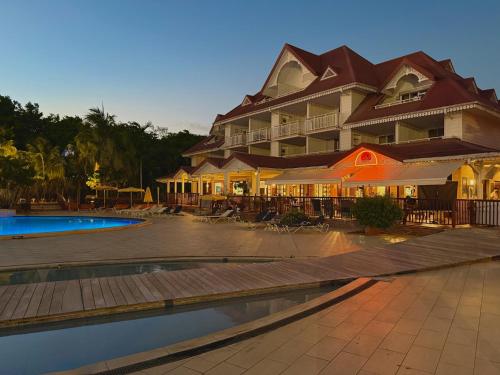 a resort with a swimming pool and a building at Studio Evasion Coco vue Jardin Tropical - Pierre & Vacances in Sainte-Luce