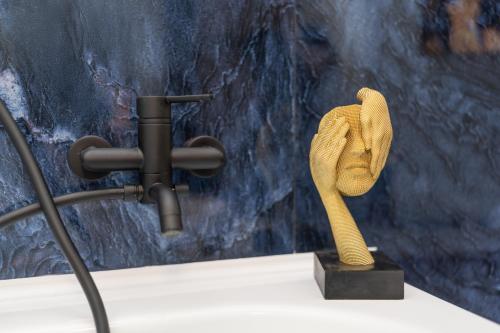 a wooden statue of a glove on a table at Le suite di Alba in Palermo