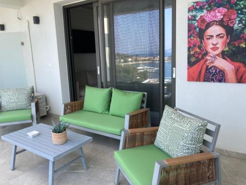 a living room with chairs and a painting of a woman at Wide Blue Luxury Boutique Suites in Neos Marmaras