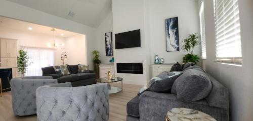 a living room with a couch and two chairs at Orlando Home Vacation near Universal Studios - 3 BR in Orlando