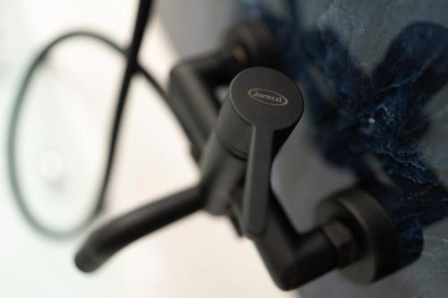 a close up of a hair dryer next to a pair of glasses at Le suite di Alba in Palermo