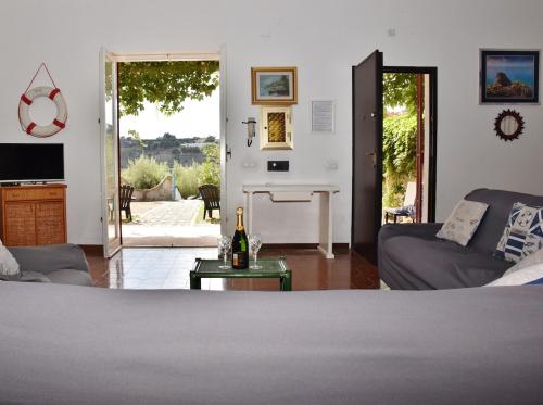 a living room with a bed and a couch and a table at Villa Bellevue in Santa Maria