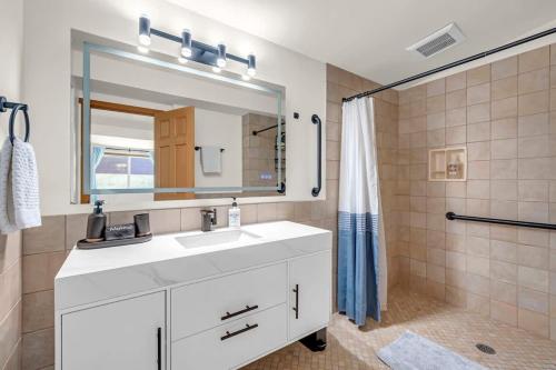 a bathroom with a white sink and a shower at Exclusive Lakefront For 10 with Sauna Kayaks Peace in Snohomish