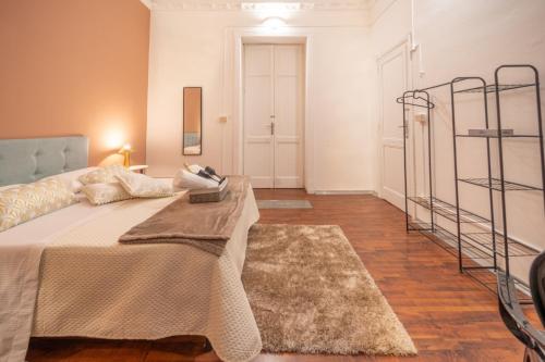 a bedroom with a large bed and a rug at Le suite di Alba in Palermo