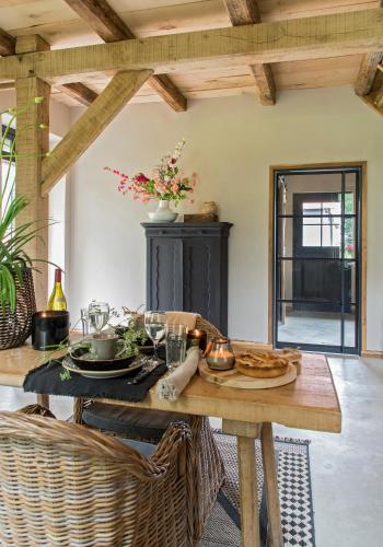 a wooden table with food on it in a room at Logeerderij Het Landleven met jacuzzi en Finse sauna Achterhoek in Vragender