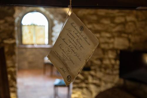 a piece of paper hanging from a string in a room at Castello di Rocca Cilento in Rocca Cilento