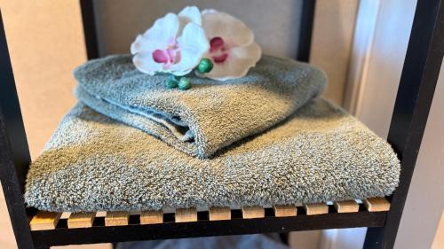 a towel on a chair with a flower on it at Sweet Sleep Apartment in Burg Stargard