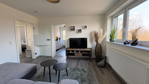 a living room with a couch and a television at Sweet Sleep Apartment in Burg Stargard