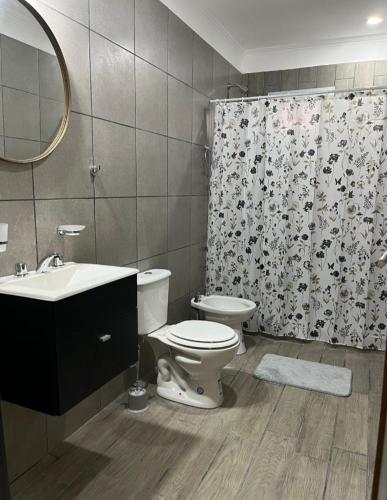 a bathroom with a toilet and a shower curtain at Junín departamento in Junín
