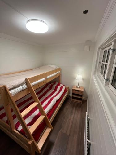 a bedroom with two bunk beds and a lamp at Stuga i Falun in Falun