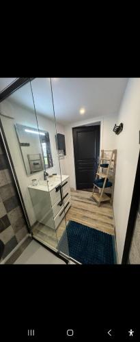 a glass room with a desk and a mirror at L alauda 
