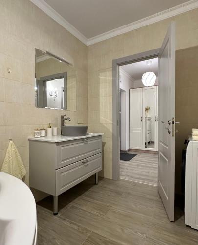 a bathroom with a sink and a mirror at ЖК "Light House", 2 in Astana